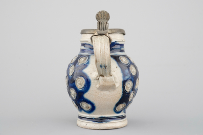 A globular Westerwald stoneware jug with appliques and pewter lid, dated 1689