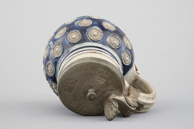 A globular Westerwald stoneware jug with appliques and pewter lid, dated 1689
