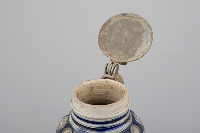 A globular Westerwald stoneware jug with appliques and pewter lid, dated 1689