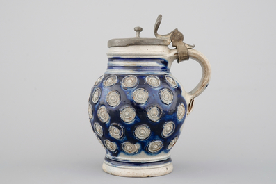 A globular Westerwald stoneware jug with appliques and pewter lid, dated 1689