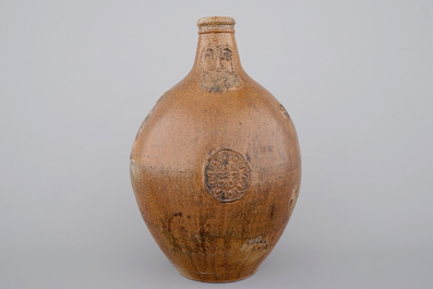 A tall Raeren saltglaze stoneware &quot;Bartmann&quot; or &quot;Beardman&quot; jug, early 17th C.