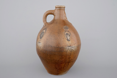 A tall Raeren saltglaze stoneware &quot;Bartmann&quot; or &quot;Beardman&quot; jug, early 17th C.