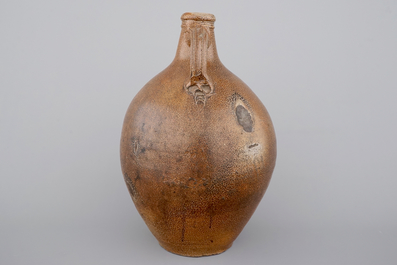 A tall Raeren saltglaze stoneware &quot;Bartmann&quot; or &quot;Beardman&quot; jug, early 17th C.