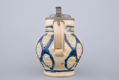 A globular Westerwald stoneware jug with applied masks, 17th C.