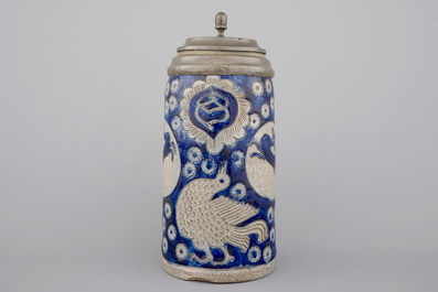 A tall Westerwald incised and pewter-mounted beer stein with deers and birds, 17th C.