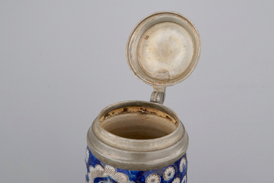 A tall Westerwald incised and pewter-mounted beer stein with deers and birds, 17th C.