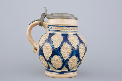 A globular Westerwald stoneware jug with applied masks, 17th C.