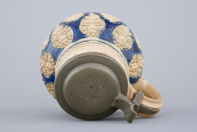 A globular Westerwald stoneware jug with applied masks, 17th C.