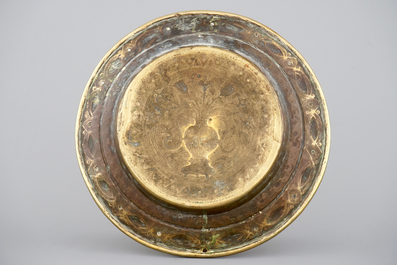 A large brass alms dish with stylised flower vase, Mechelen, 17th C.