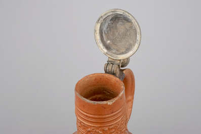 A tall Raeren stoneware jug with the Roman god Mercury, dated 1618