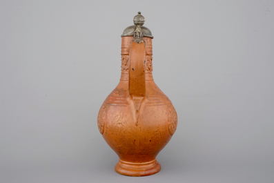 A tall Raeren stoneware jug with the Roman god Mercury, dated 1618