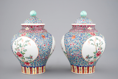 A pair of Chinese porcelain famille rose jars and covers, 20th C.