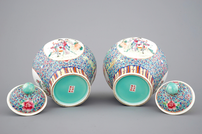 A pair of Chinese porcelain famille rose jars and covers, 20th C.