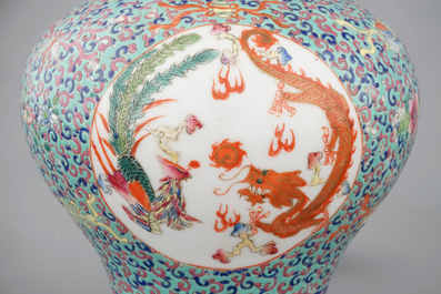 A pair of Chinese porcelain famille rose jars and covers, 20th C.