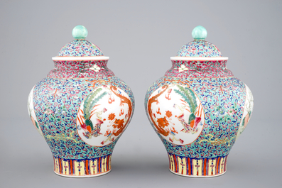 A pair of Chinese porcelain famille rose jars and covers, 20th C.