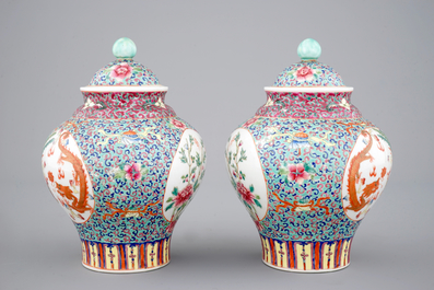 A pair of Chinese porcelain famille rose jars and covers, 20th C.