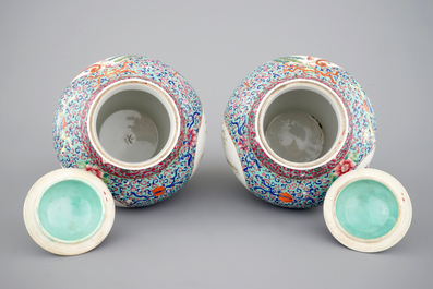 A pair of Chinese porcelain famille rose jars and covers, 20th C.