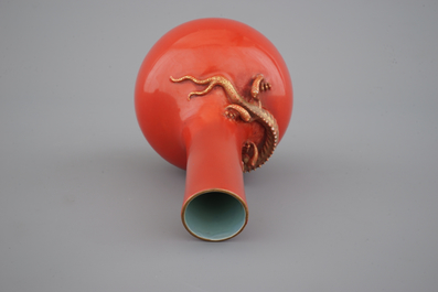 A Chinese porcelain coral red ground dragon vase, 19th C.