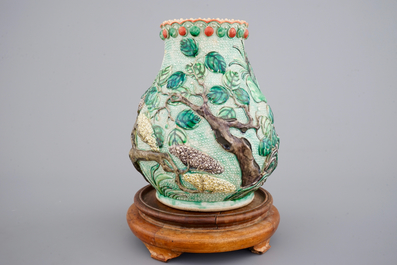 A Nanking famille verte relief-decorated hu-shaped landscape vase, 19th C.