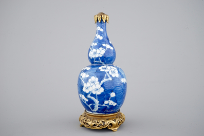Un vase en porcelaine de Chine au fond bleu, orn&eacute; d'une monture chinoiserie en bronze, 18/19&egrave;me