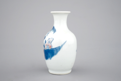 A Chinese porcelain blue and underglaze red vase with a playing boy, 19/20th C