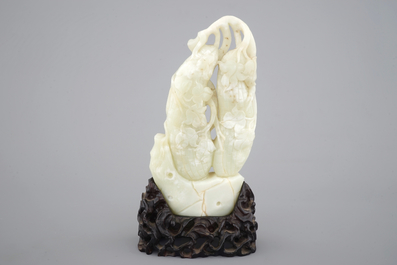 A Chinese carved celadon jadeite model of hanging vegetables on a carved wood stand, early 20th C