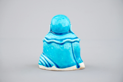 A Chinese porcelain turquoise figure of a seated Buddha, Kangxi