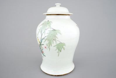 A Chinese famille rose vase and cover with birds on a branch, 19th C.