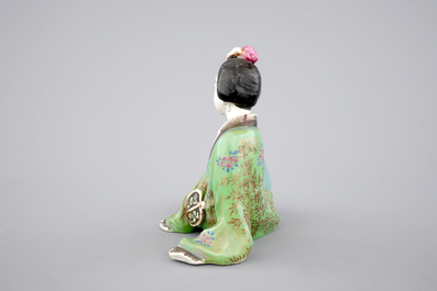 A Chinese famille rose porcelain figure of a reclining lady, 20th C