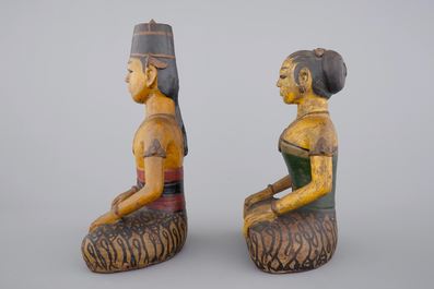 Two tall Indonesian cold-painted pottery figures of servants, 19th C.