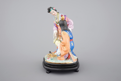A fine Chinese porcelain figural group on a wooden stand, 20th C