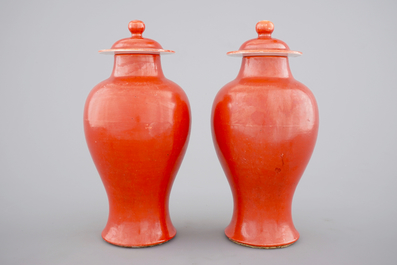 A pair of Chinese monochrome coral ground baluster vases with cover, 19th C.