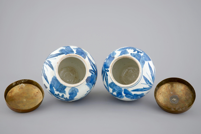 A pair of blue and white Japanese porcelain vases with brass covers in Chinese transitional style, Edo, 17th C.