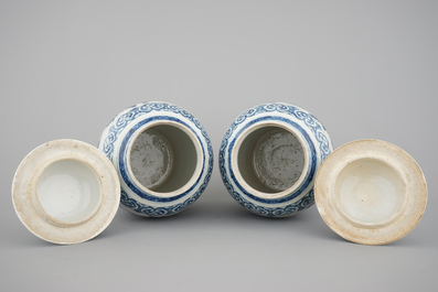 A pair of blue and white Chinese porcelain dragon vases and covers, 19th C.