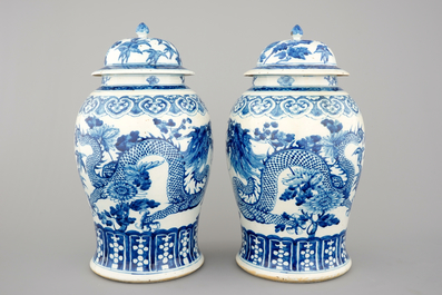 A pair of blue and white Chinese porcelain dragon vases and covers, 19th C.