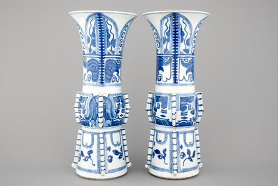 An unusual pair of tall Chinese blue and white porcelain gu-shaped vases, Kangxi, ca. 1700