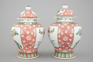 A pair of Chinese famille verte porcelain baluster vases and covers, 19th C.