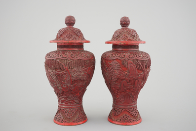 A pair of Chinese carved cinnabar lacquer vases and covers, 18/19th C