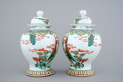 A pair of Chinese wucai porcelain warrior vases with covers, 19/20th C.