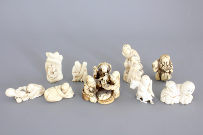 A set of 9 small Japanese ivory carvings, incl. netsuke, on a small red lacquer table, 19th/early 20th C.