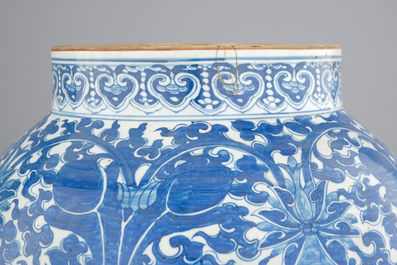 A tall blue and white Chinese porcelain vase and cover with lotus scrolls, 19th C.