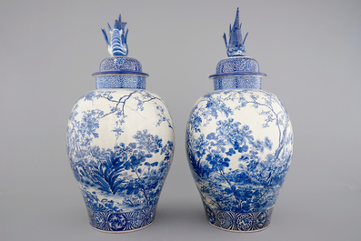 A tall pair of Japanese Arita porcelain blue and white vases and covers, ca. 1860