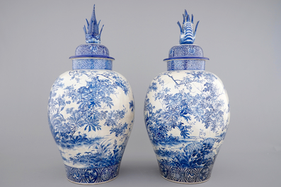 A tall pair of Japanese Arita porcelain blue and white vases and covers, ca. 1860