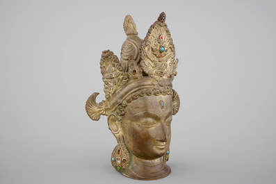 A tall gilt bronze head of a Boddhisatva with semi-precious stones, Tibet, 17/18th C.