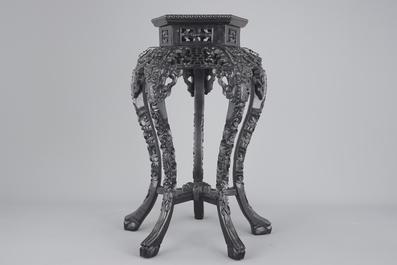 An intricately carved Chinese hardwood marble top vase stand, 19th C.