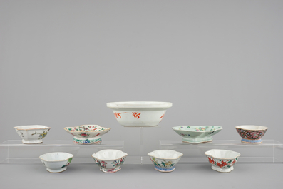 A Chinese famille rose basin with a bird on a branch and 8 smaller bowls, 19th C.