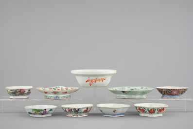 A Chinese famille rose basin with a bird on a branch and 8 smaller bowls, 19th C.