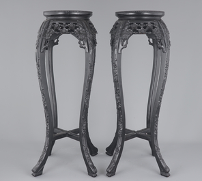 A tall pair of Chinese carved stands with marble top, 19th C.
