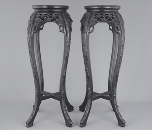 A tall pair of Chinese carved stands with marble top, 19th C.