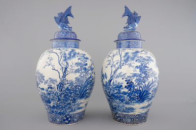 A tall pair of Japanese Arita porcelain blue and white vases and covers, ca. 1860